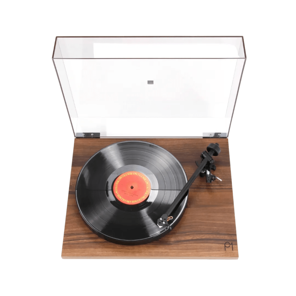 Rega Planar 1 turntable with a beautiful walnut finish, transparent dust cover, and a vinyl record playing, showcasing a minimalist and premium design. ​