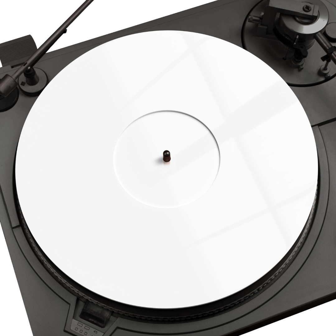 Close-up view of a Pro Spin acrylic record mat placed on a black turntable platter, featuring a transparent white surface with concentric grooves.