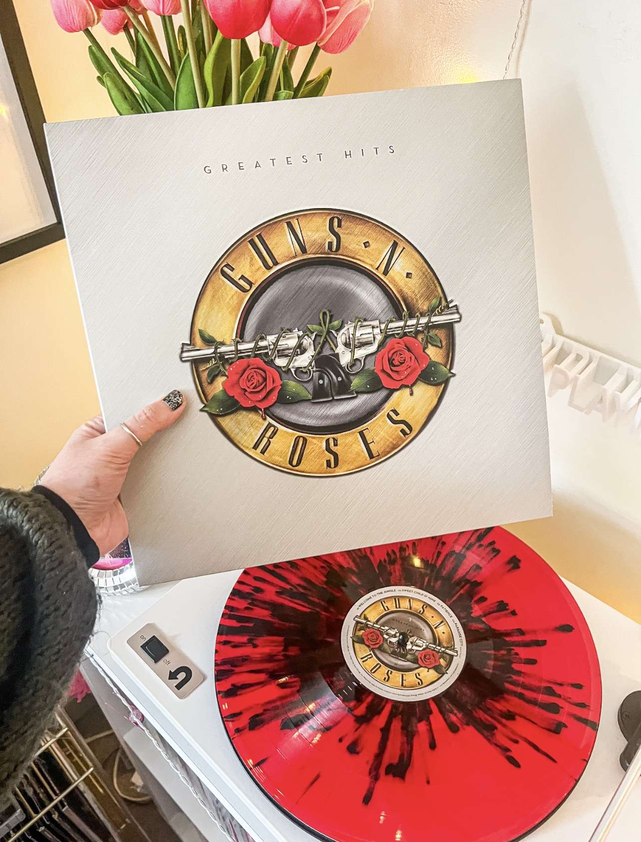 Red and black splatter Guns N’ Roses vinyl on a turntable