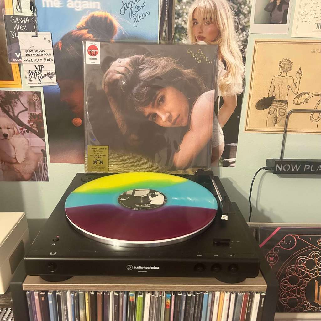 A tri-color vinyl in yellow, teal, and purple spinning on an Audio-Technica LP60X, paired with Clairo – Charm album art displayed behind.