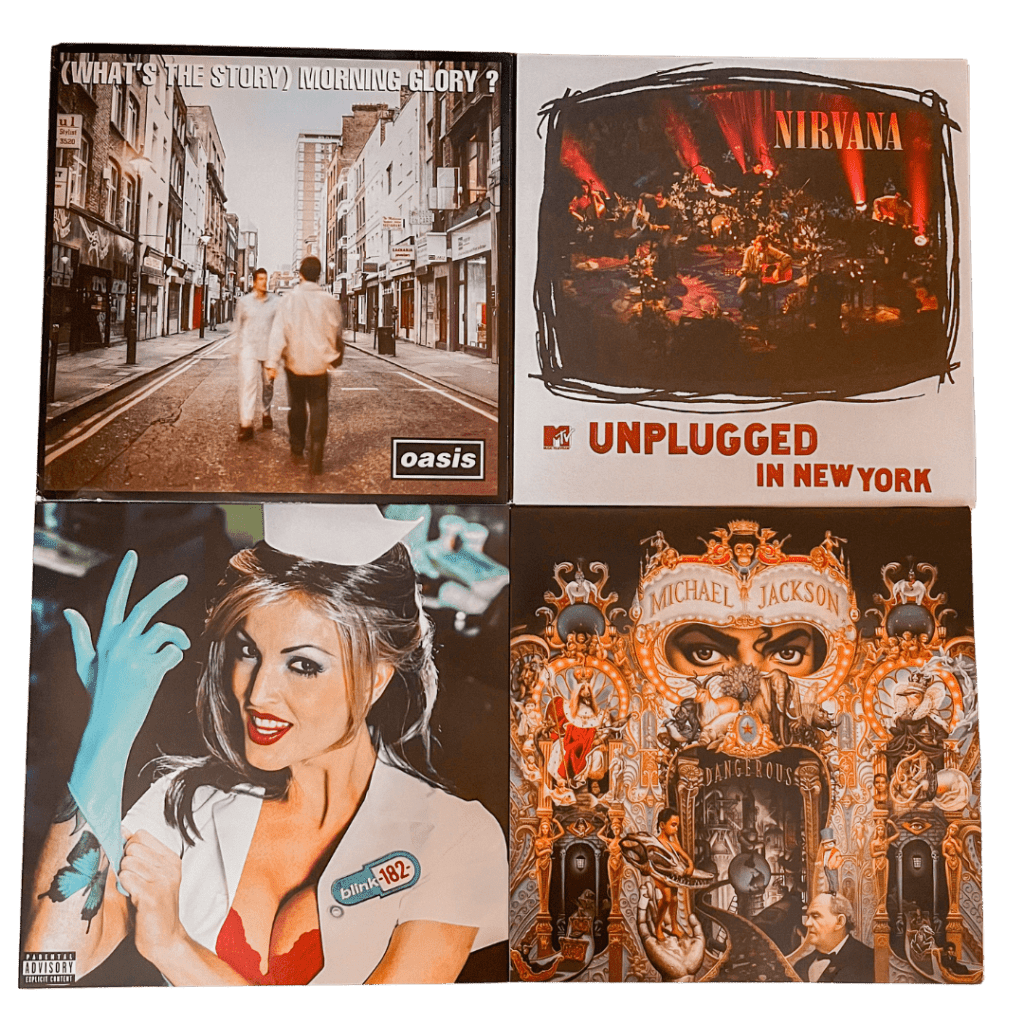 Four iconic vinyl covers: Oasis’ (What’s the Story) Morning Glory? with two men crossing a London street, Nirvana’s MTV Unplugged in New York showing the band surrounded by flowers on stage, Blink-182’s Enema of the State featuring a nurse in a suggestive pose, and Michael Jackson’s Dangerous with a surreal carnival mask design filled with intricate illustrations.