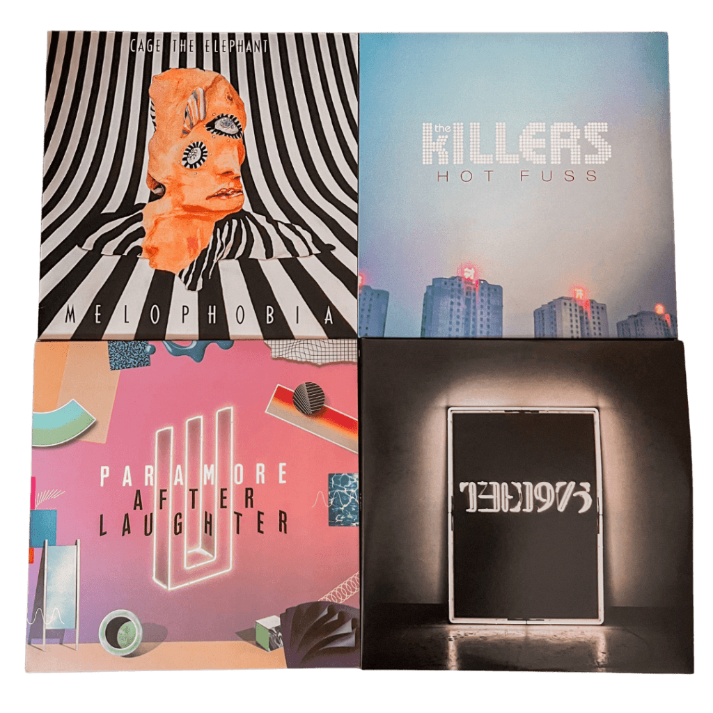 Four vinyl records: Cage the Elephant’s Melophobia with surreal striped artwork and distorted face illustration, The Killers’ Hot Fuss with a soft blue cityscape, Paramore’s After Laughter with colorful geometric designs and neon-style text, and The 1975’s self-titled album with a minimalist black cover and glowing white frame around the band’s name.
