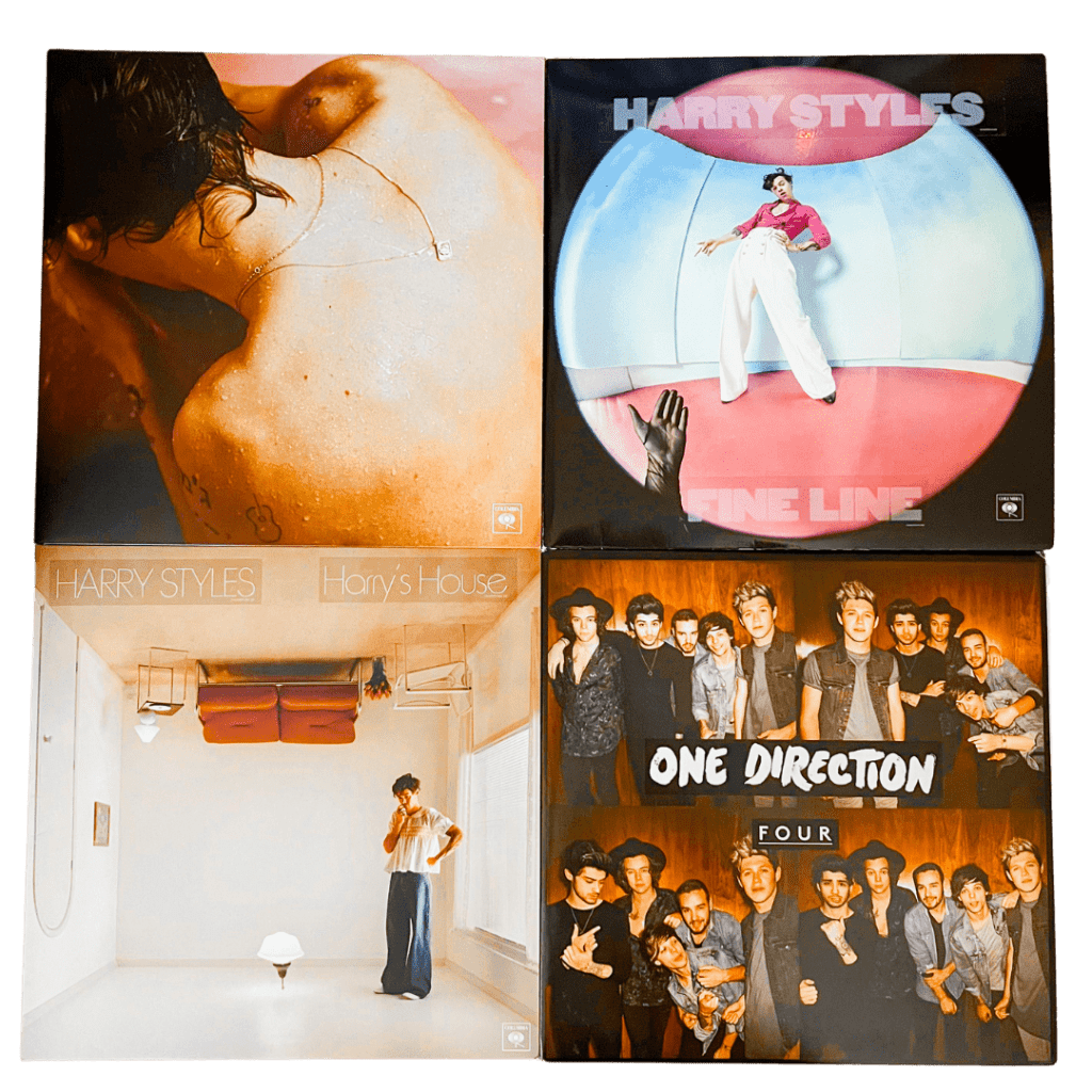 Four vinyl records: Harry Styles’ debut self-titled album showing him submerged in water from behind, Harry Styles’ Fine Line with the artist standing in a fisheye pink-and-blue room, Harry’s House featuring Styles standing in an upside-down minimalist living room, and One Direction’s Four with a group shot of all band members in casual outfits.