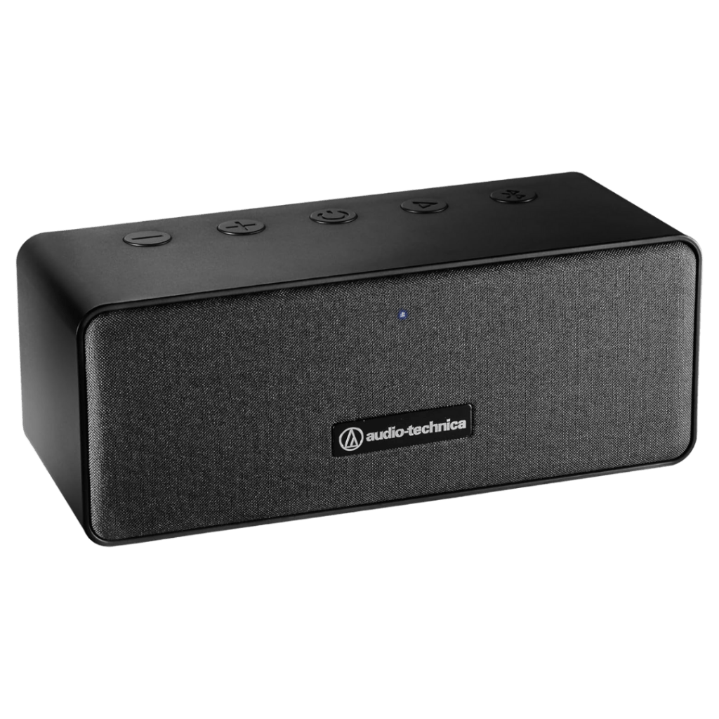 Audio-Technica AT-SP65XBT portable Bluetooth speaker in black, featuring a fabric front grille and control buttons on top.