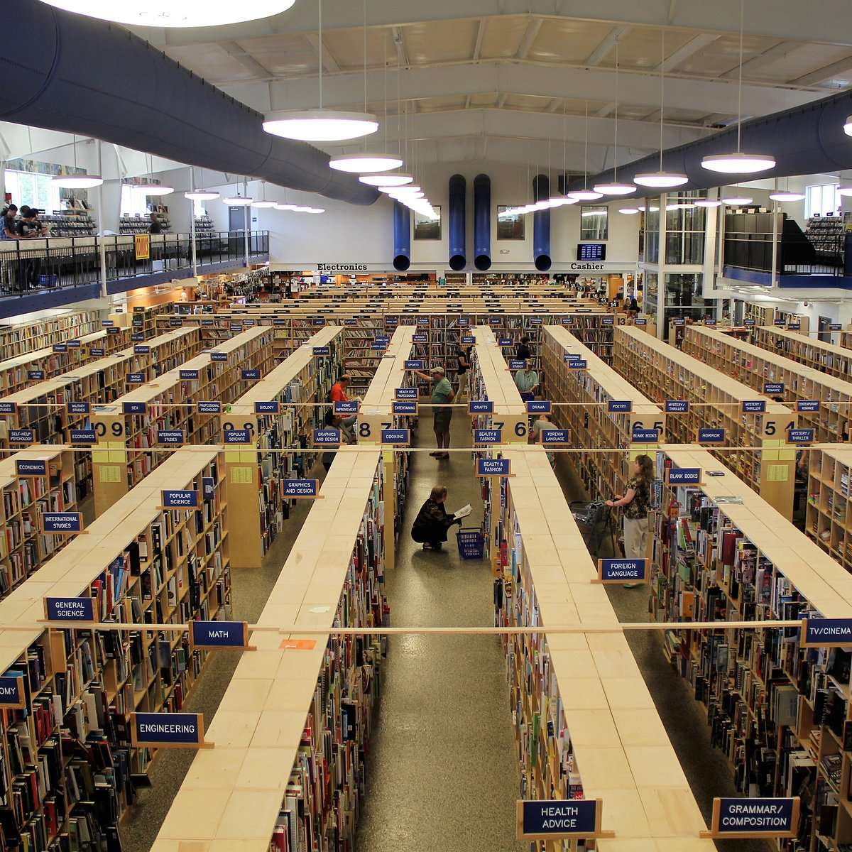 Interior of McKay’s bookstore and media store with massive rows of shelves filled with books, music, and records organized by category