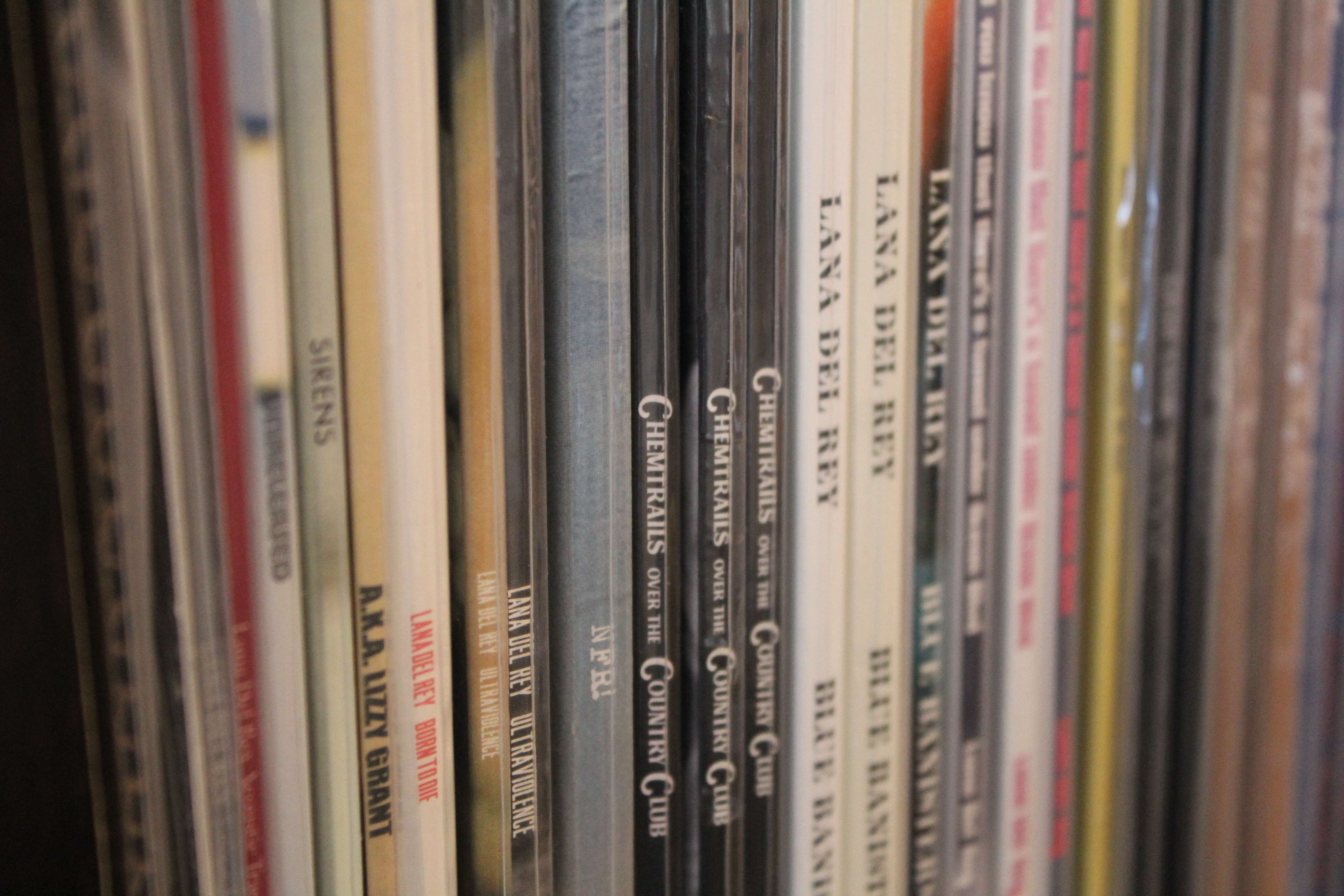 Close-up of Lana Del Rey Born to Die vinyl among record spines