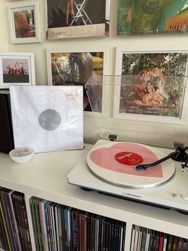 Snail Mail — “Valentine” heart-shaped pink vinyl on a white Audio-Technica turntable, gallery wall behind.