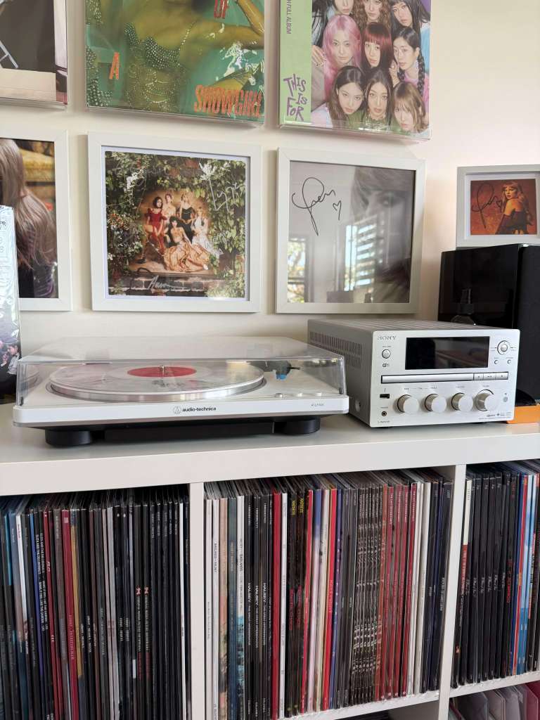Turntable close-up: white AT-LP70X with clear LP next to a silver Sony CMT-G2BNiP receiver under framed album art.
