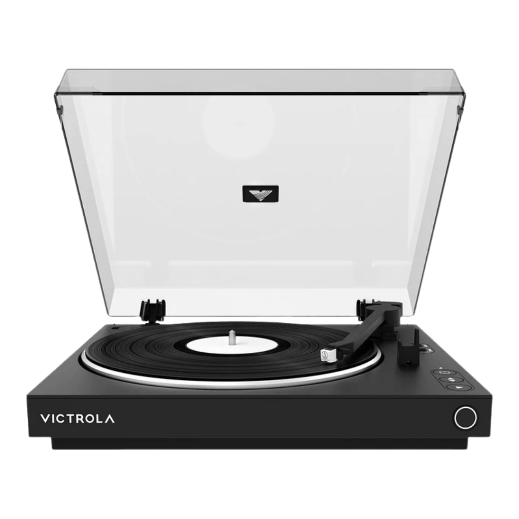 Front view of a black Victrola turntable with the clear dust cover open, a vinyl record on the platter, and the tonearm resting to the right.