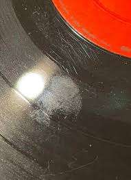 dusty vinyl record with fingerprints